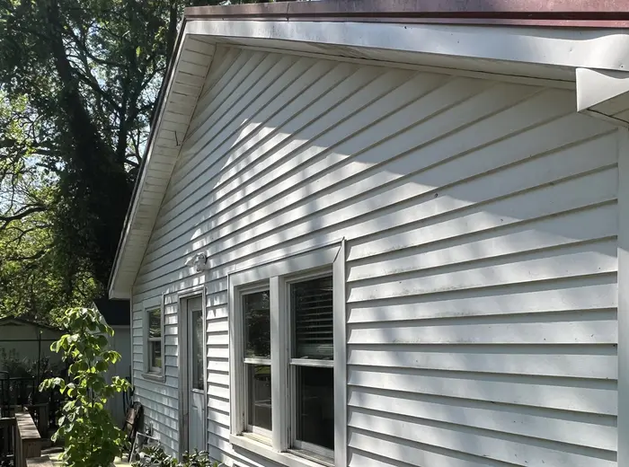 Vinyl siding dulled by mildew before a soft wash