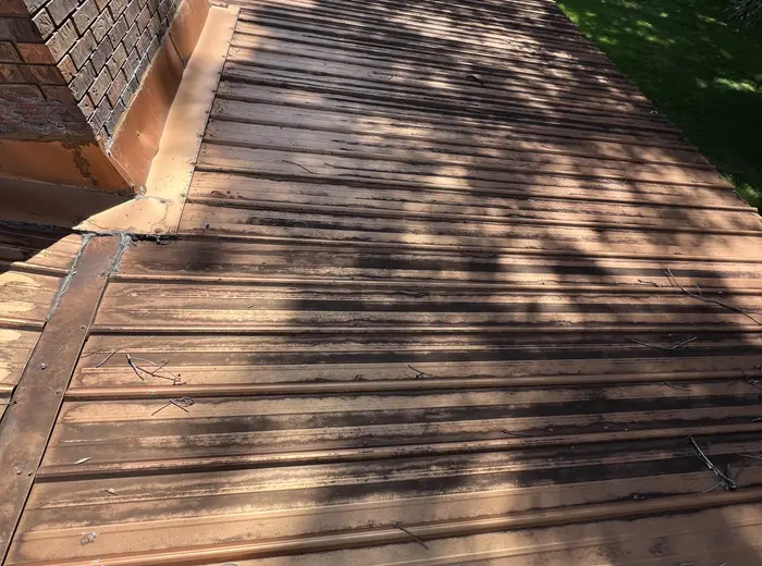 Metal roof darkened with staining before washing