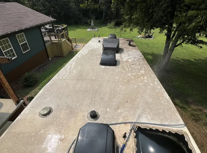 RV roof streaked with grime before washing