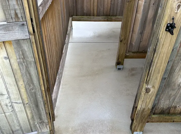 Concrete and fencing under a deck cleaned back to bare surface