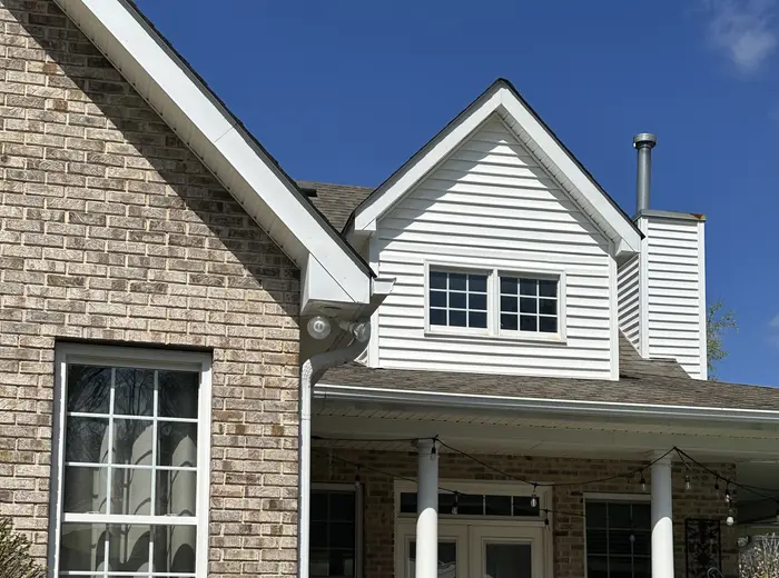 Brick home with a clean porch and white columns